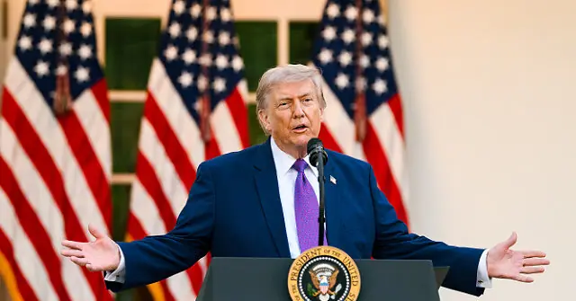 The image shows a person speaking at a podium with the seal of the President of the United States, with American flags in the background.