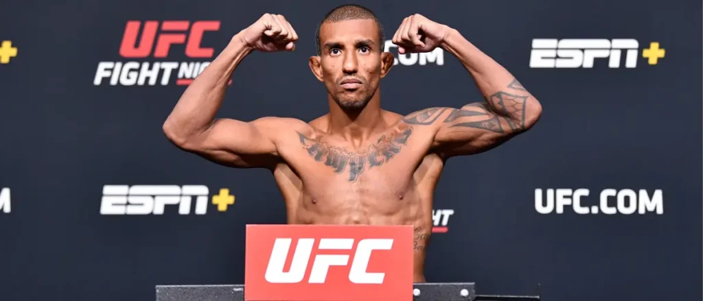 A fighter flexes his muscles at a UFC weigh-in event.