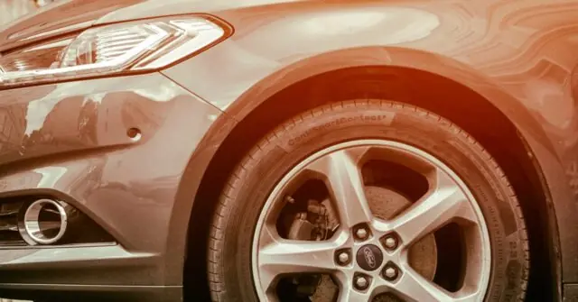 The image shows a close-up of a car's front wheel and part of the front fender, highlighting the tire and wheel design.