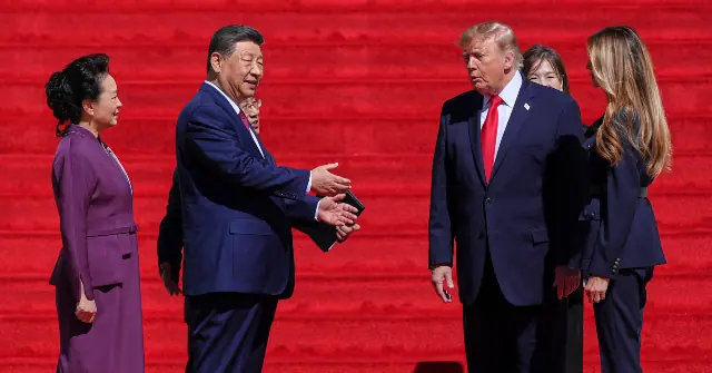 The photo shows a formal interaction between two leaders, with one extending a hand in a gesture of greeting or agreement.
