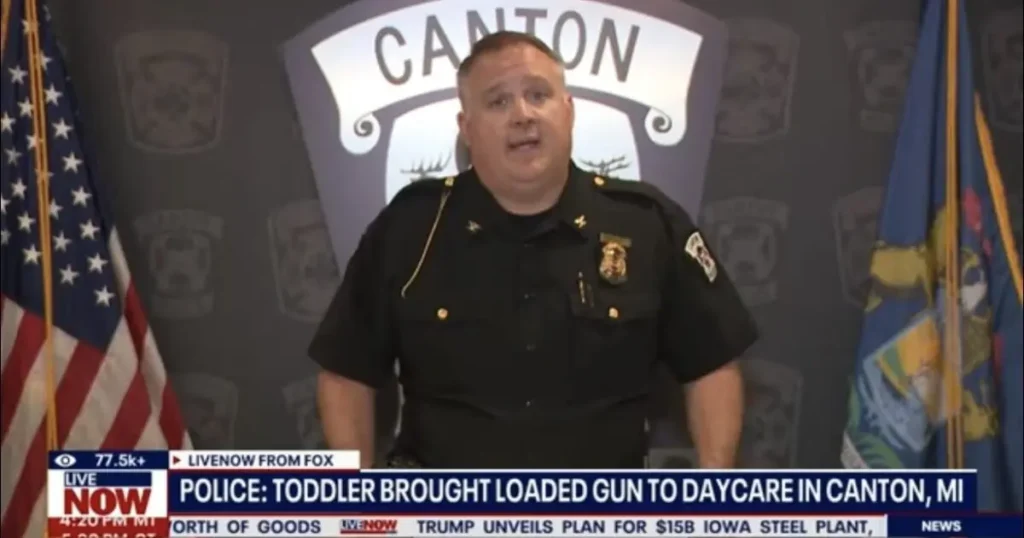 A police officer speaks at a press conference about a toddler bringing a loaded gun to a daycare in Canton, MI.