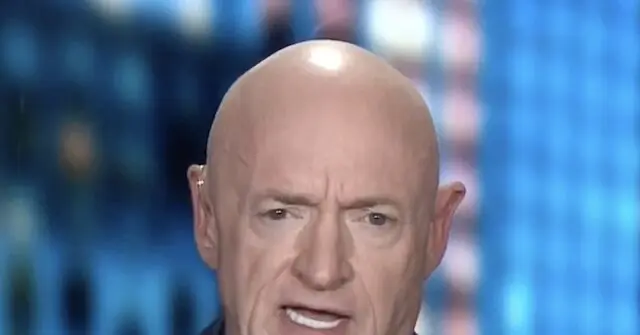 The image shows a close-up of a bald individual with a serious expression, set against a blurred background with blue tones.