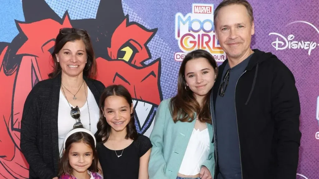 A family poses together at a Marvel's "Moon Girl and Devil Dinosaur" event.