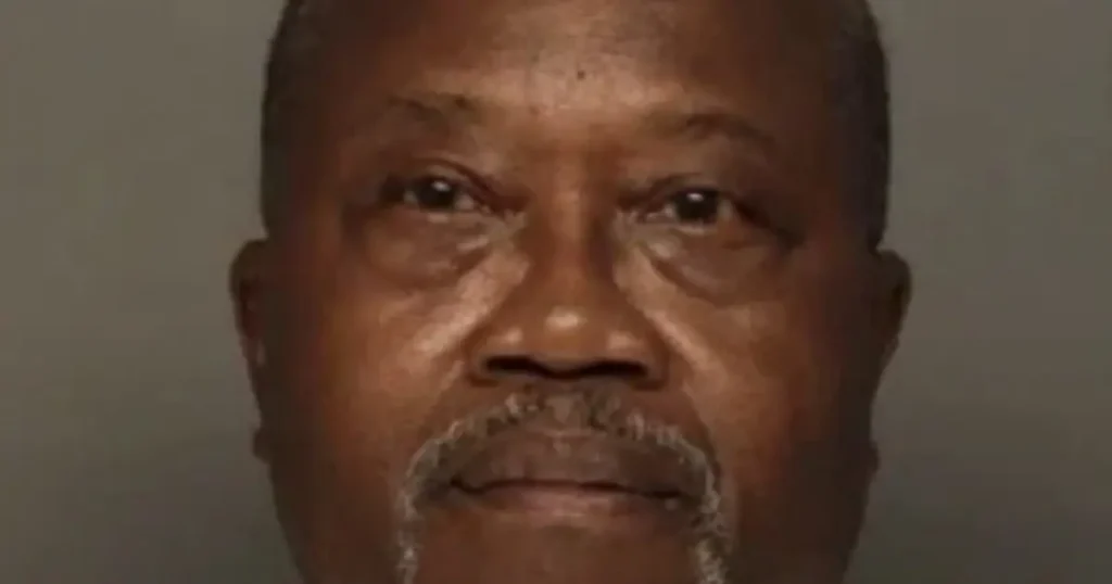The image appears to be a mugshot of a man with a neutral expression.