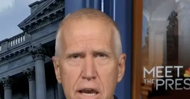 The image shows a man speaking on a news program, with a backdrop featuring a classical building and the text "MEET THE PRES."