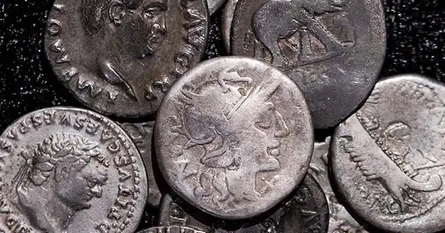 The image shows a collection of ancient Roman coins, featuring various emperors and symbols.