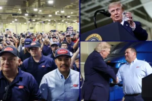 The photo shows a group of workers in blue uniforms and caps, with one individual shaking hands with a man in a suit, likely during a visit or event at a manufacturing facility.