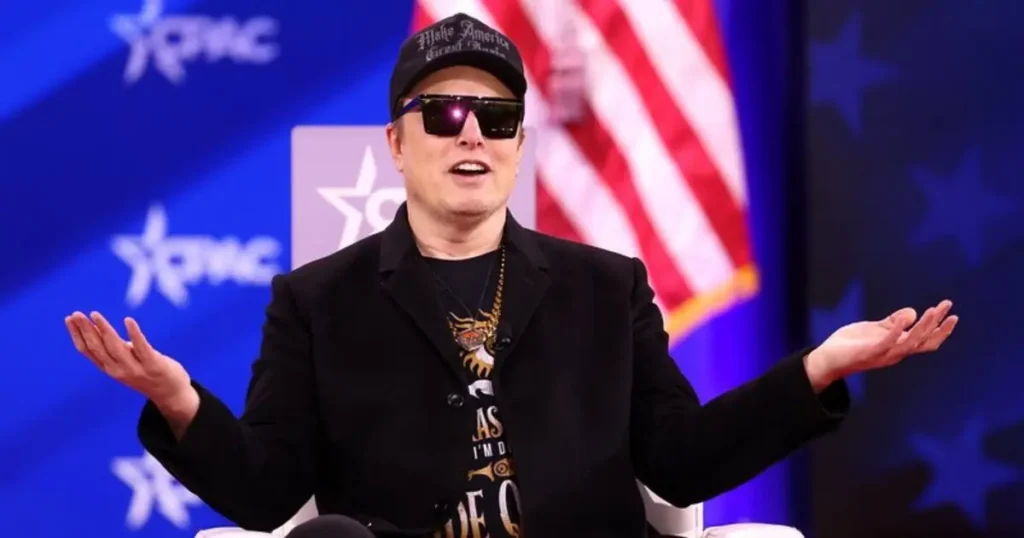 The image shows a person speaking at a podium with an American flag and "CPAC" in the background, suggesting a political or conservative event.