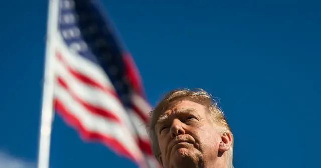 The image shows a person looking upward with an American flag waving in the background against a clear blue sky.