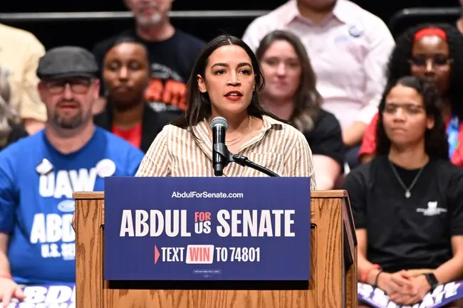 A woman speaks at a podium during a campaign event for Abdul for U.S. Senate.