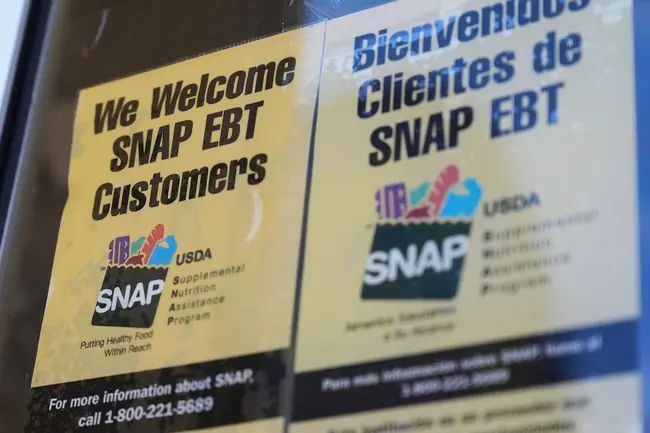 The photo shows signs welcoming SNAP EBT customers, indicating the Supplemental Nutrition Assistance Program, in both English and Spanish.