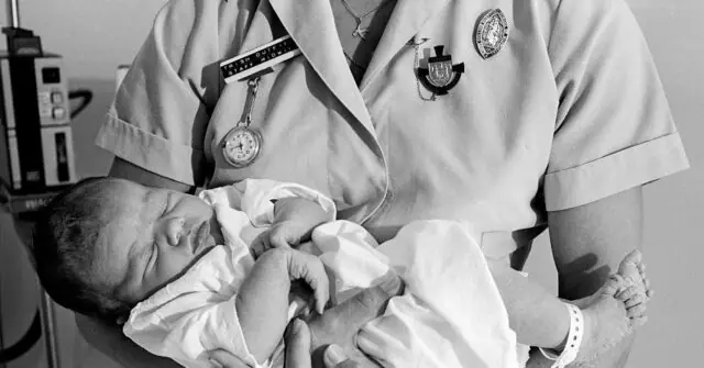 A nurse holds a newborn baby wrapped in a blanket, symbolizing care and new beginnings.