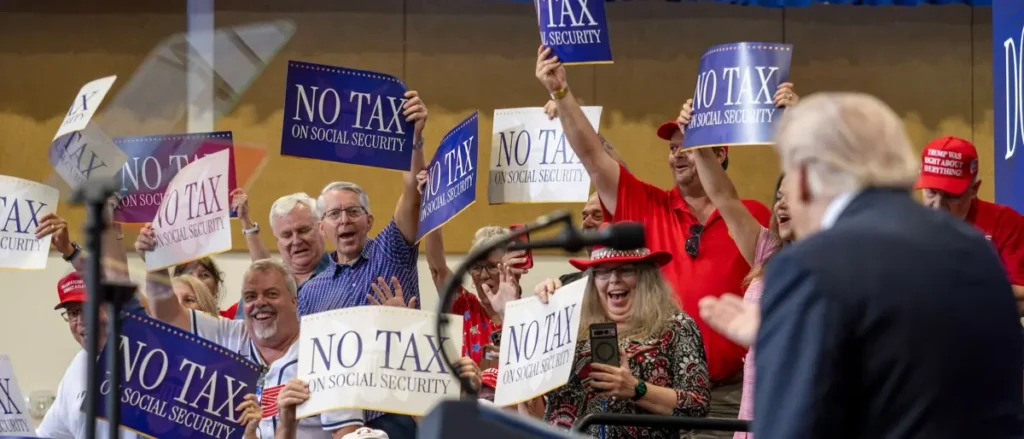 A group of people hold signs advocating for "No Tax on Social Security" during a public event.