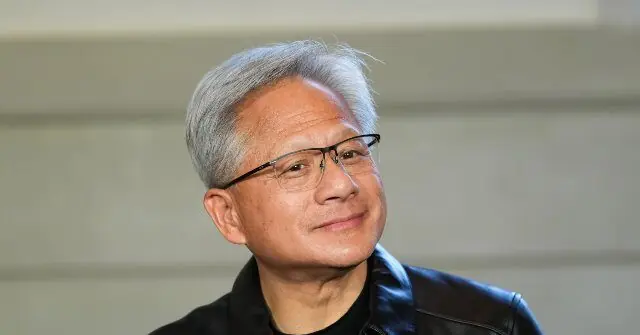 The image shows a person wearing glasses and a black jacket, looking to the side with a thoughtful expression.