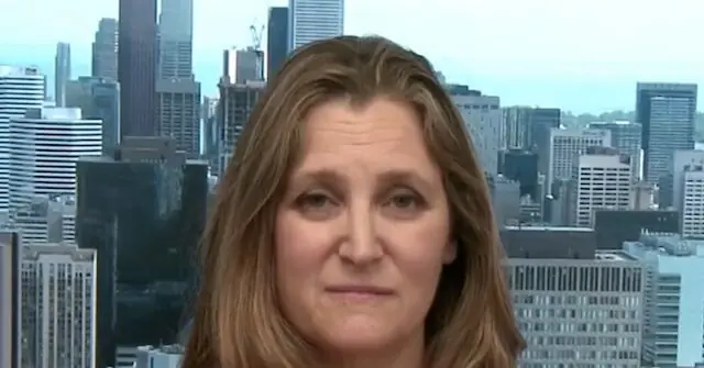 The news photo features a person with long hair in front of a cityscape background.