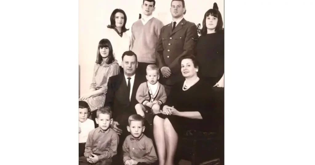 This is a vintage family portrait featuring adults and children dressed in formal attire, likely from the mid-20th century.