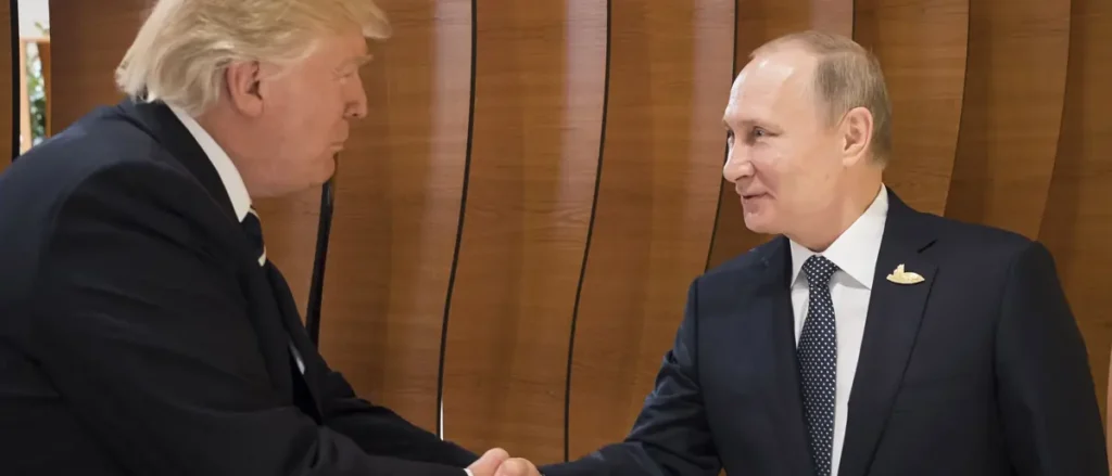 The image shows two individuals in formal attire shaking hands in a professional setting.