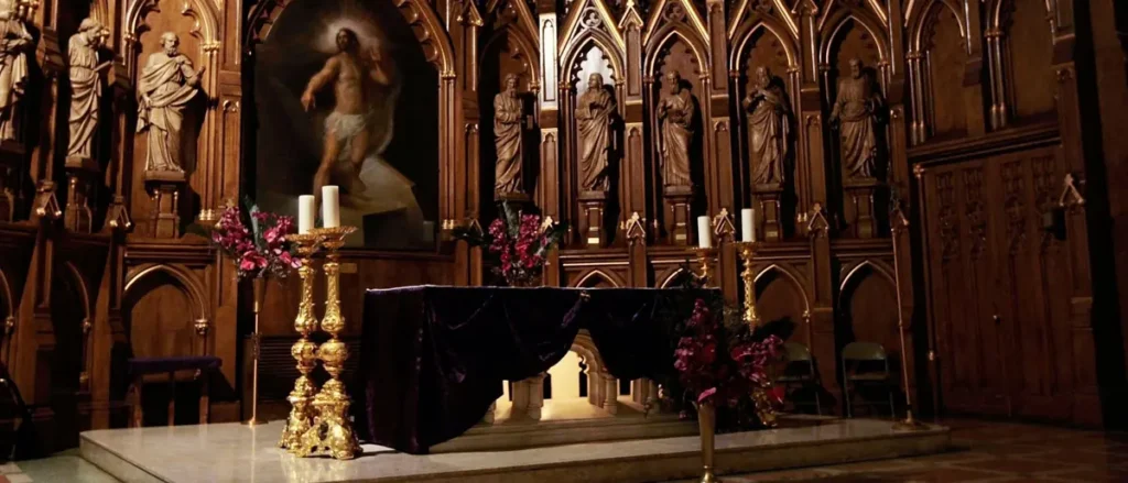 The image depicts the interior of a church with a gothic-style altar, statues, and a central painting of Jesus Christ.