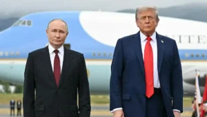The image shows two individuals in formal attire standing in front of a large aircraft, likely during a diplomatic or official visit.