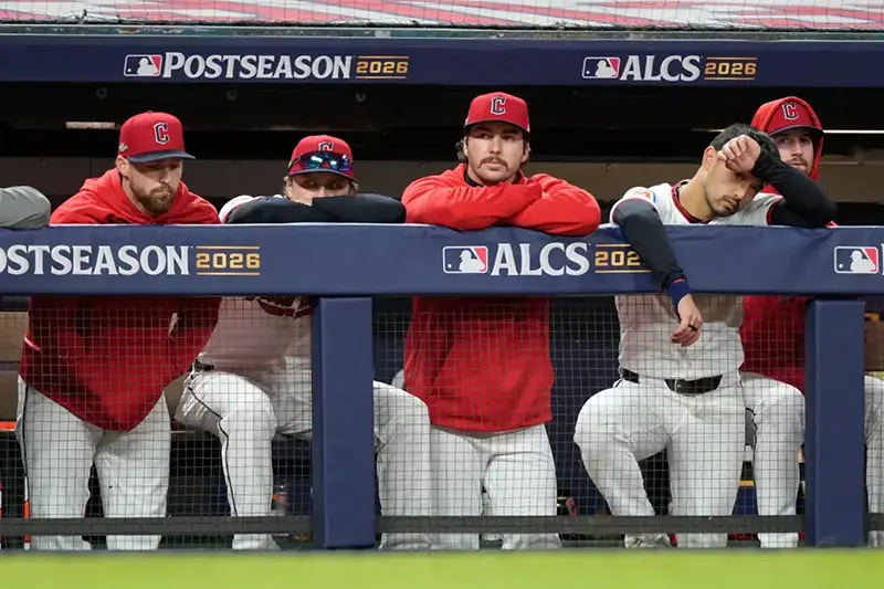 A group of baseball players in the dugout during the 2026 ALCS, appearing contemplative or tired.