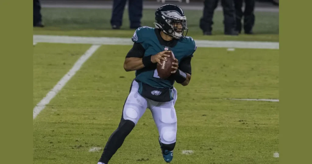 A Philadelphia Eagles quarterback is seen in action, preparing to throw the football during a game.