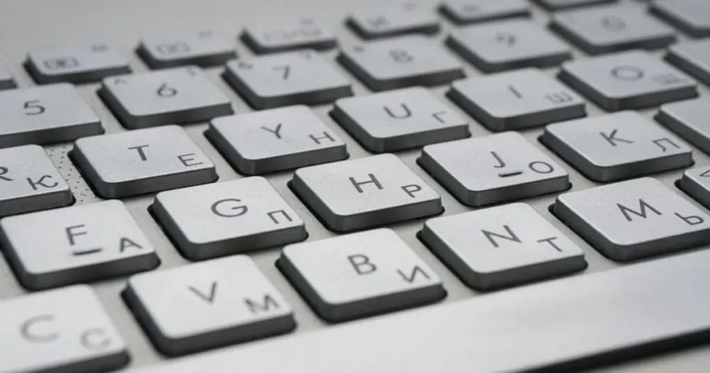 The image shows a close-up of a keyboard with Cyrillic and Latin characters, suggesting a dual-language input setup.