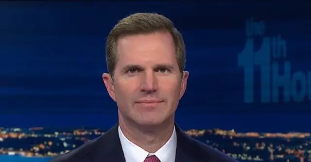 The image shows a news anchor in a suit and tie, set against a backdrop featuring the "11th Hour" logo and a cityscape at night.