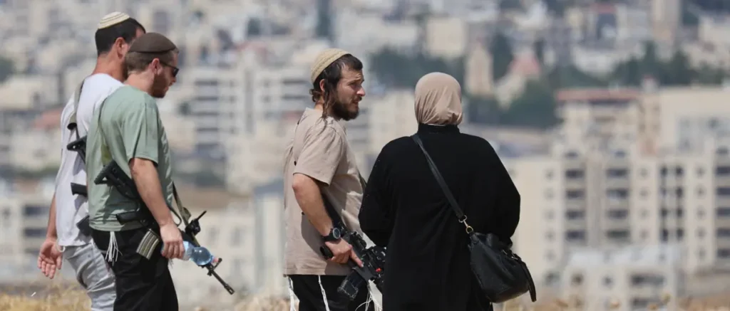 A group of individuals, some carrying firearms, are seen overlooking a cityscape.