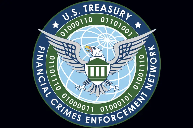 The image shows the logo of the U.S. Treasury Financial Crimes Enforcement Network, featuring an eagle and a shield with binary code around it.