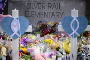 A memorial at Silver Rail Elementary features flowers, candles, and symbolic decorations in honor of those affected.