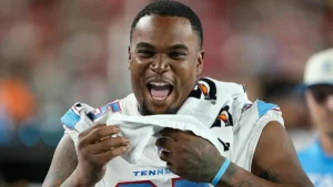 The image shows a football player in a Tennessee uniform celebrating with a towel.