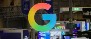 The image shows a large, colorful "G" sign, likely representing Google, displayed at an event or exhibition.
