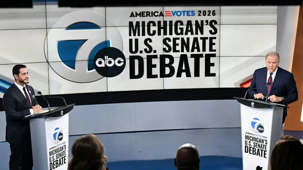 Two candidates are participating in a Michigan U.S. Senate debate on stage.