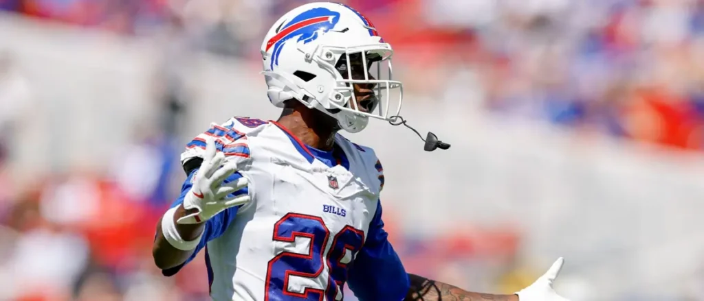 A Buffalo Bills football player is seen in action during a game, wearing a helmet and jersey with the number 29.