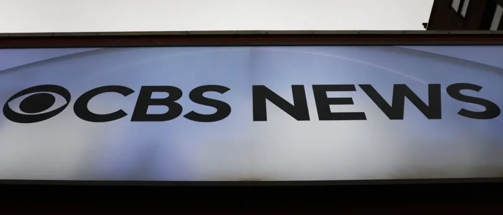 The image shows a CBS News sign on a building.