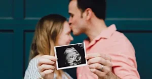 A couple celebrates their pregnancy news by sharing an ultrasound image.