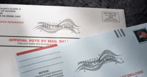 The image shows an official mail-in ballot envelope for voting, authorized by the U.S. Postal Service.