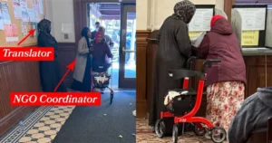 The photo shows a translator and an NGO coordinator assisting a woman with a walker in a polling station.