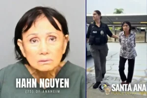 The image shows Hahn Nguyen, a 75-year-old woman from Anaheim, being escorted by a police officer from the Santa Ana Police Department.