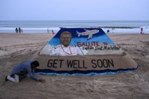 A sand sculpture on a beach salutes Captain Smit Machchhar and wishes him a speedy recovery.