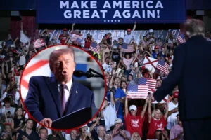 The image depicts a political rally with a crowd holding American flags and signs, and a prominent slogan "MAKE AMERICA GREAT AGAIN!" displayed on a large screen.