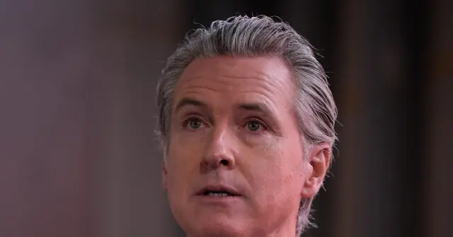 The image shows a close-up of a person with gray hair, looking slightly to the side with a serious expression.