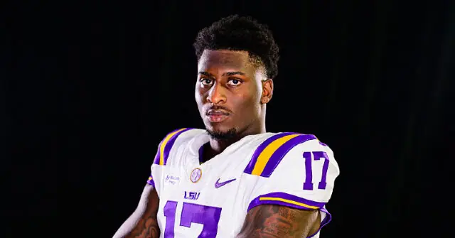 The image shows a football player wearing a white jersey with purple and yellow accents, the number 17, and the LSU logo, standing against a dark background.
