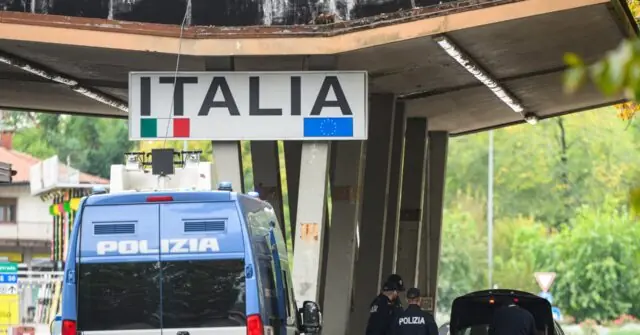 A police van is parked under an "ITALIA" sign at a border crossing, with two officers standing nearby.