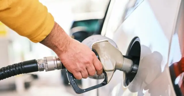 A person is refueling a car at a gas station.