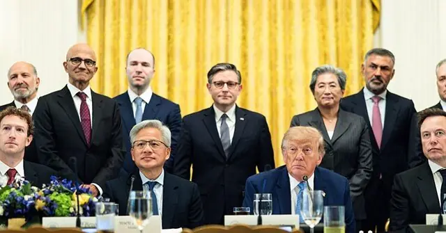 The image shows a formal meeting with a group of individuals in suits, seated and standing, in what appears to be a government or official setting.
