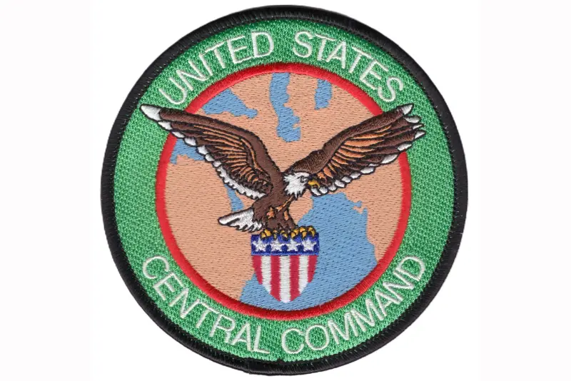 The image shows the patch of the United States Central Command, featuring an eagle and the American flag.