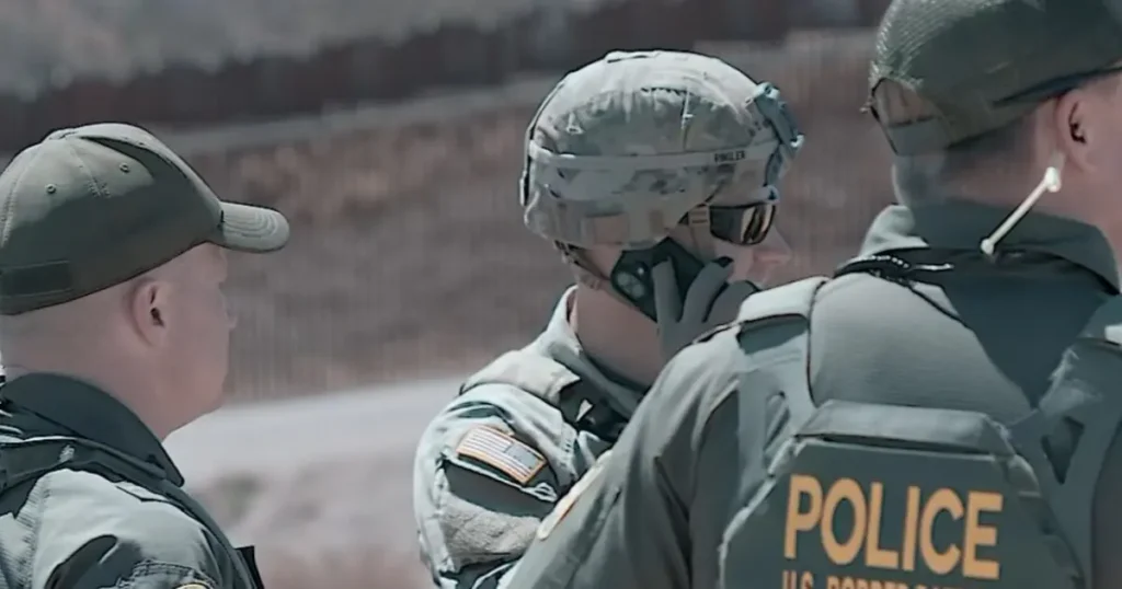 The image shows three individuals in tactical gear, including a person wearing a "POLICE" vest, engaged in a discussion in an outdoor setting.