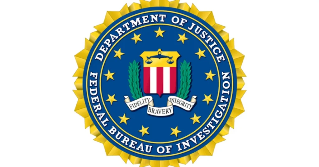 The image shows the seal of the Federal Bureau of Investigation (FBI), which is part of the Department of Justice.