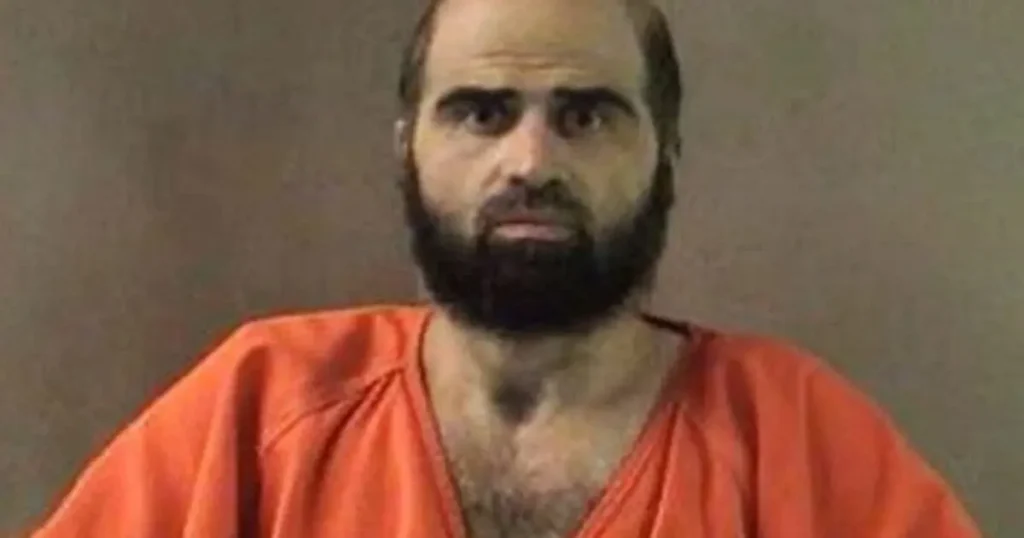 The image shows a person wearing an orange prison uniform, commonly associated with inmates in correctional facilities.